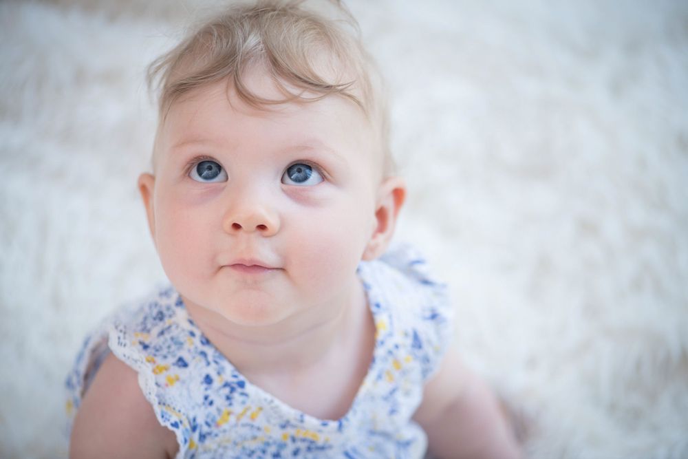 A candid moment of an 9 month old girl during an Newborn in-home photoshoot in Ashtead, Surrey