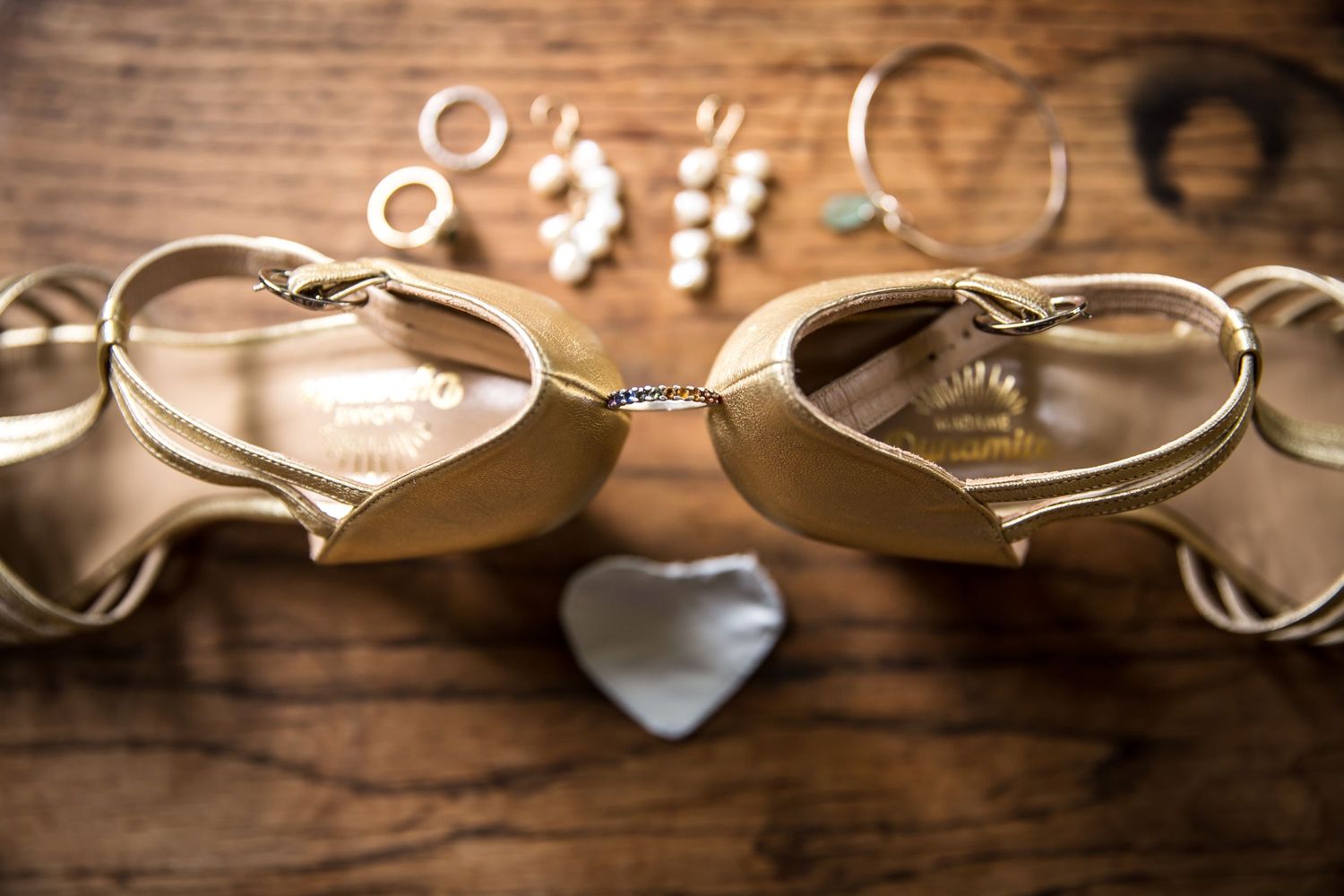 Bridal shoes surrounded by the bride's jewellery that she will wear on her wedding day