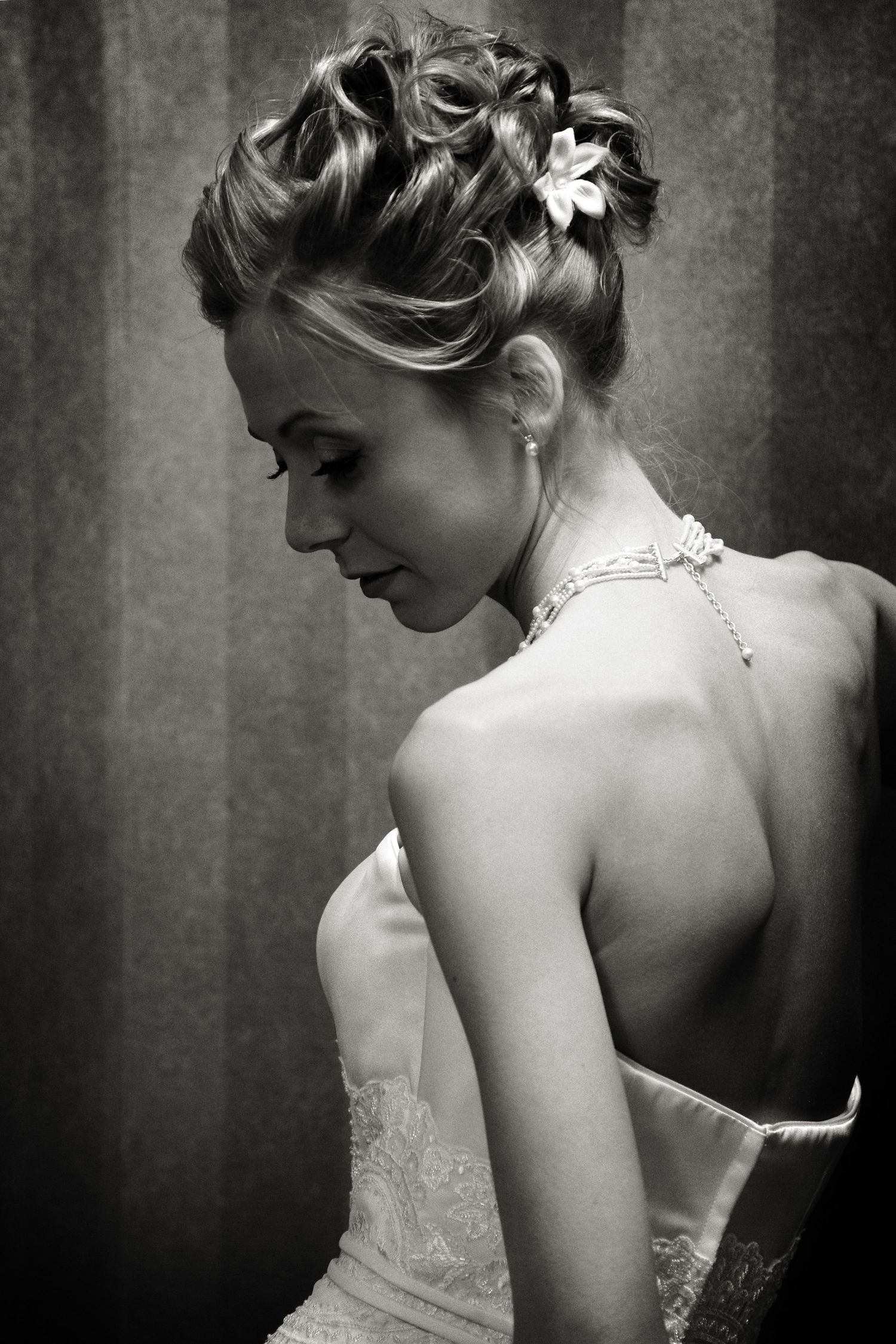 Artistic black and white portraits showcase the intricate details of a strapless wedding gown.