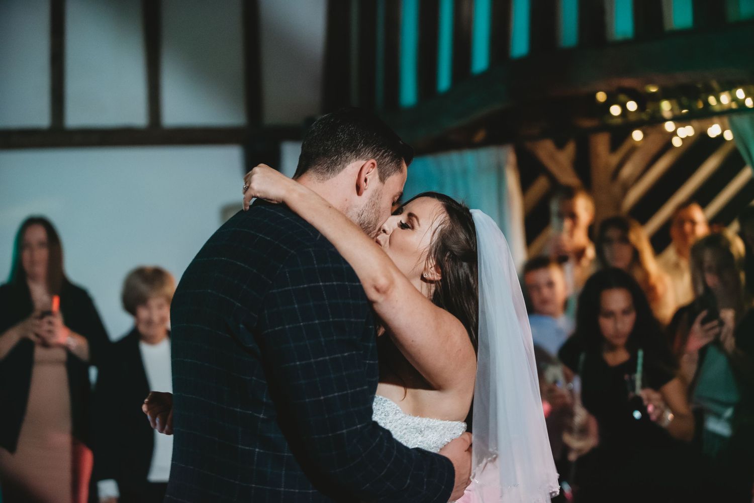 First dance moment under atmospheric lighting at wedding reception.