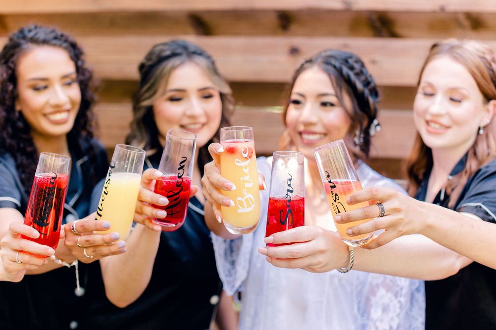 Group toasting with colorful drinks in matching robes.