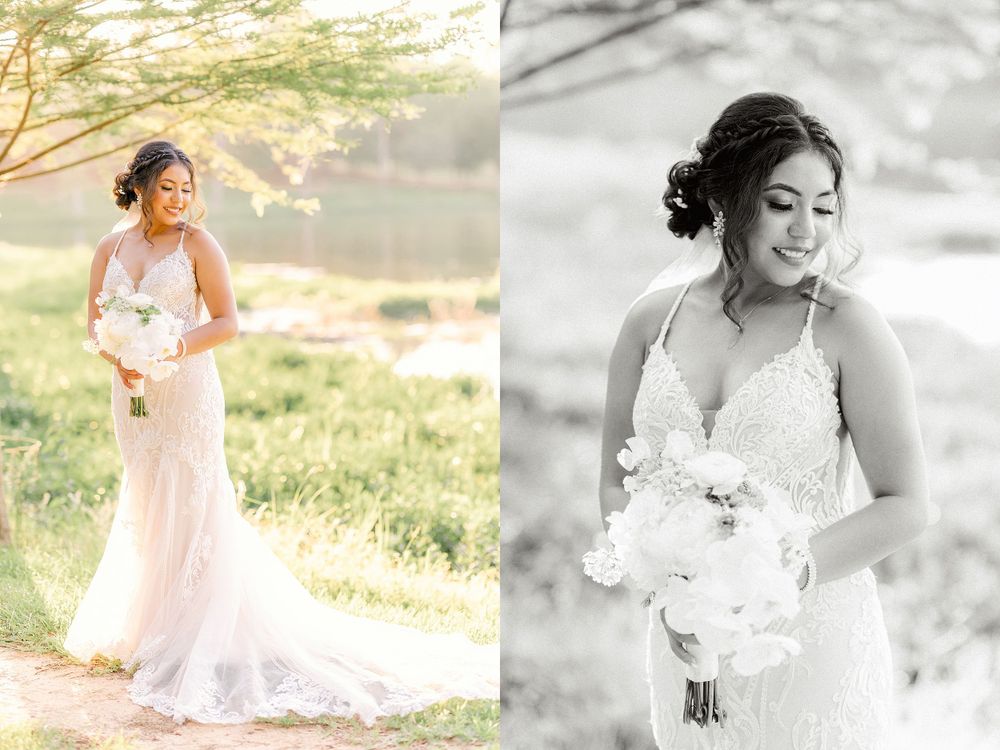 A bride in a flowing lace wedding dress poses elegantly in golden sunlight holding a white floral bouquet.