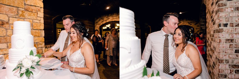 A couple shares intimate moments while cutting their elegant white wedding cake.