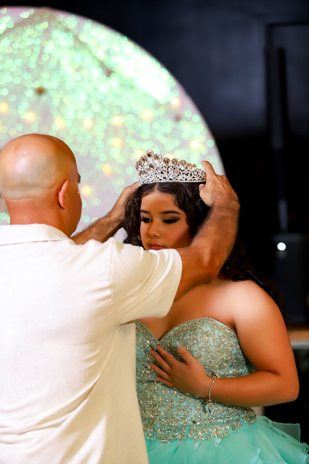 A sparkling tiara is carefully placed during a special celebration moment.