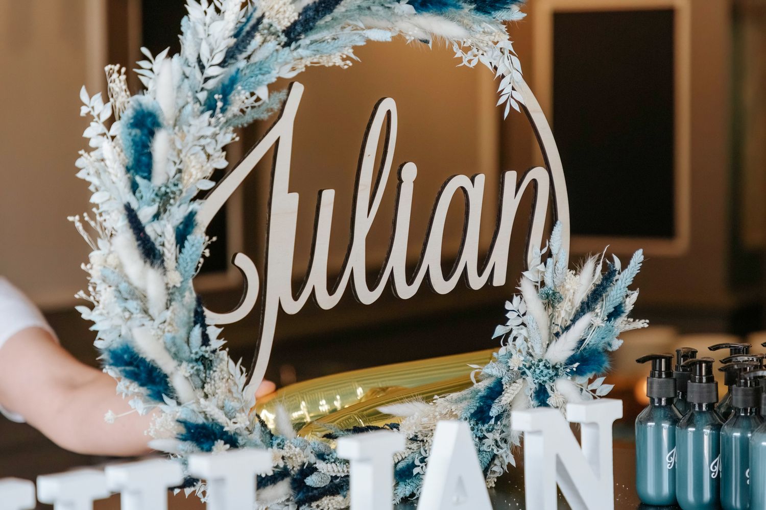 A decorative winter-themed wreath with the name Julian in script and blue frosted accents.