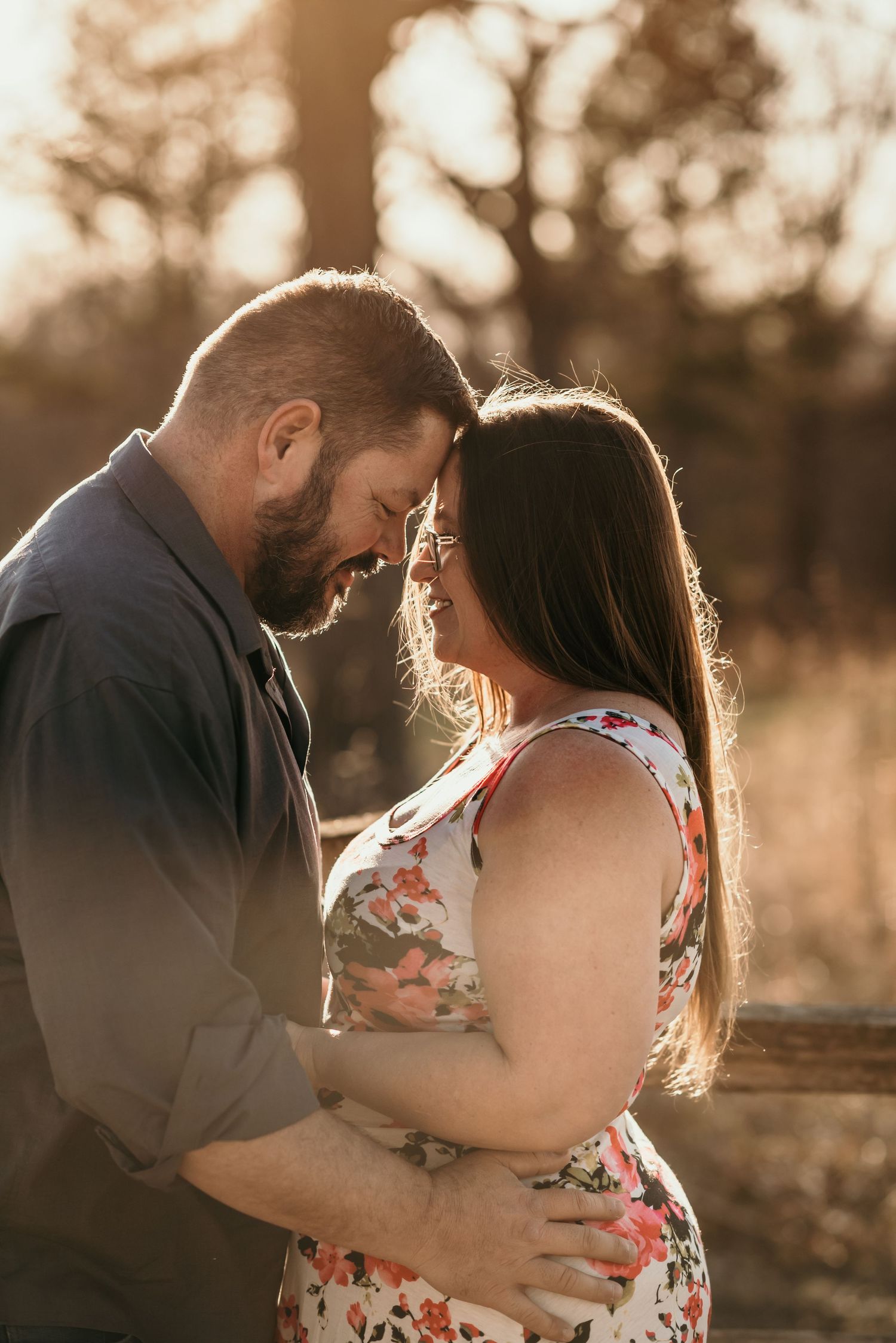 A romantic sunset engagement photo shows a couple embracing in warm golden light.