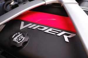 Close-up of a Viper engine cover with red paint and chrome lettering.