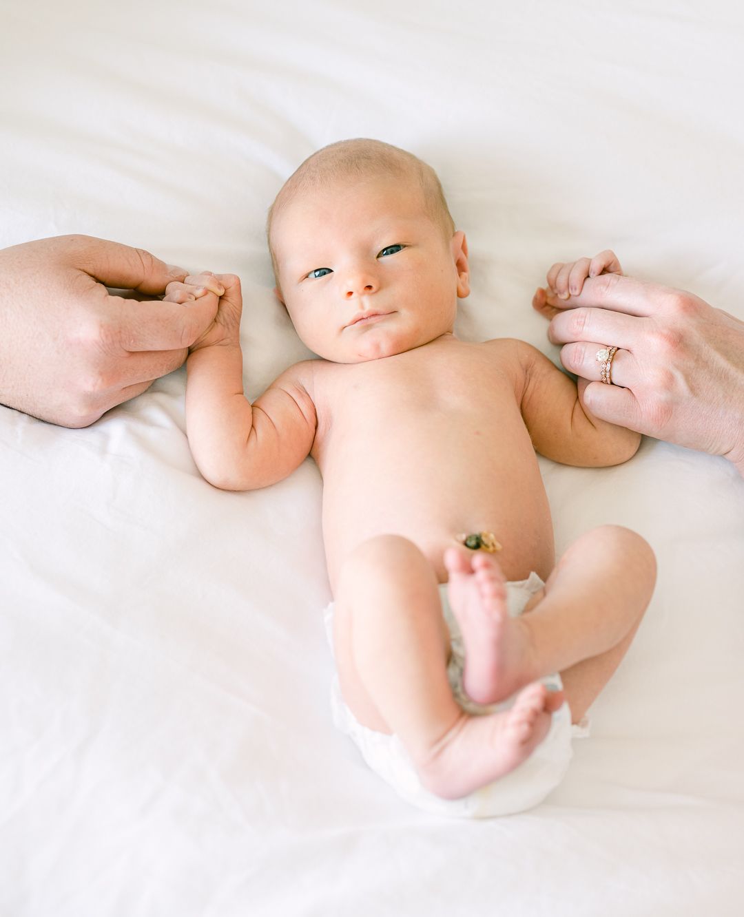 newborn baby on mom's bed in Salt Lake City Utah for pictures with Michelle Deppe Photography.