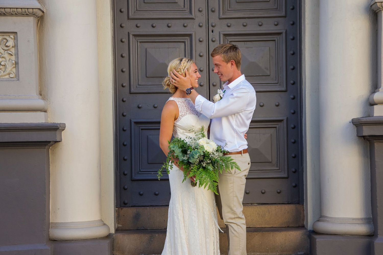 bride and groom in fremantle looking at eachother smiling
