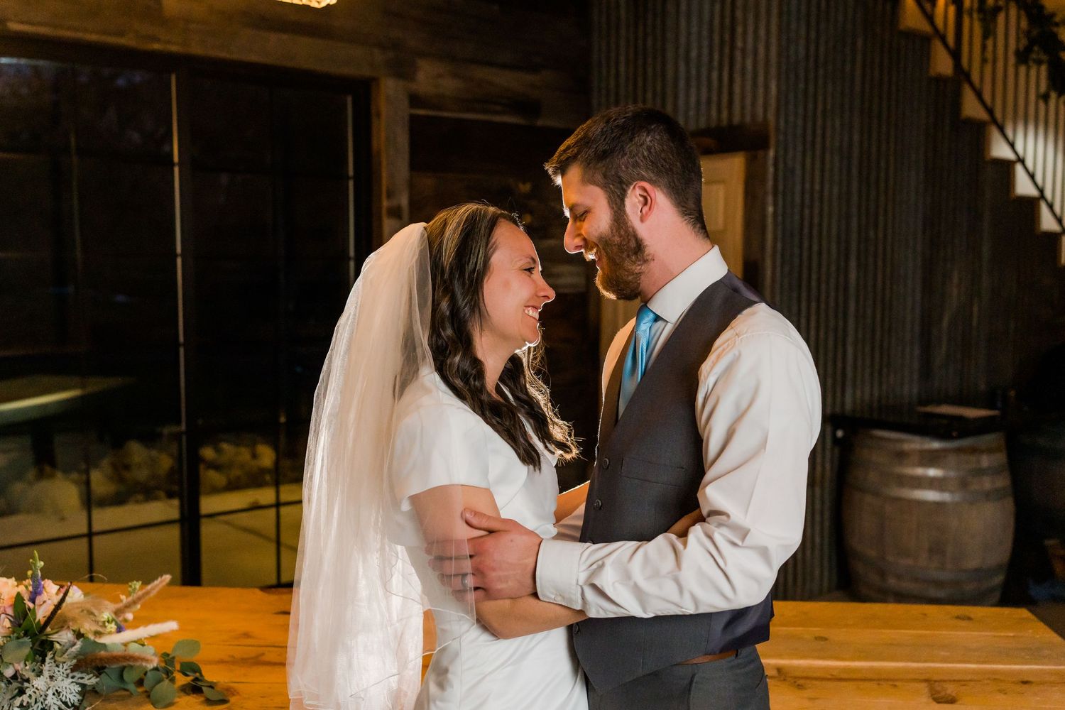 bride and groom laugh and hold each other
