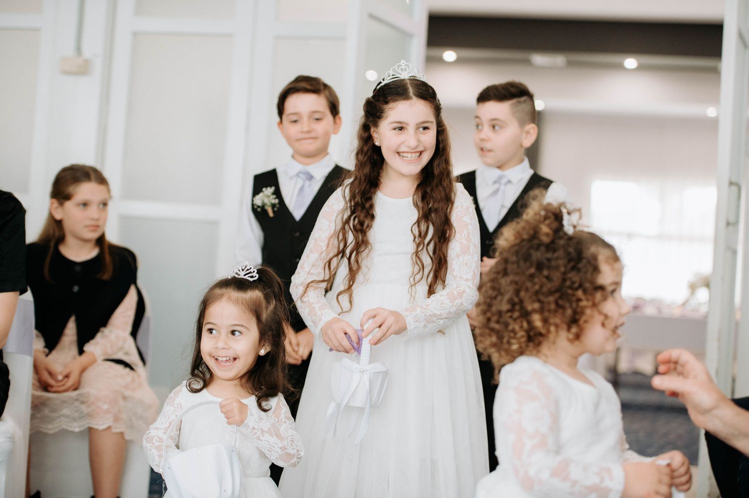 Wedding party members gather in formal attire for a celebratory moment.