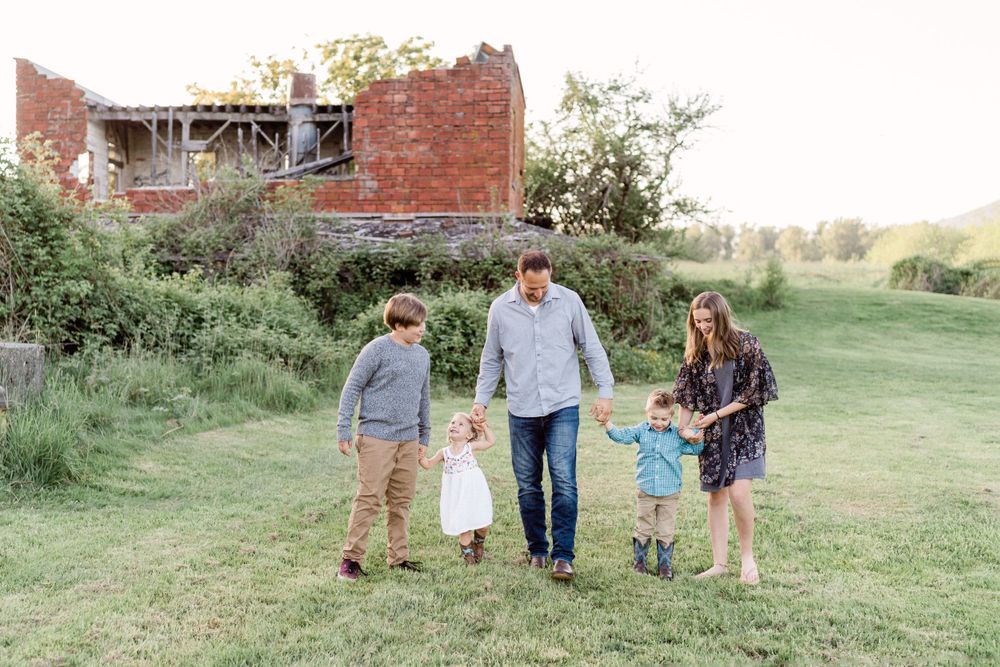 family walks in front of crumbling building lifestyle photos spring portraits dad with kids