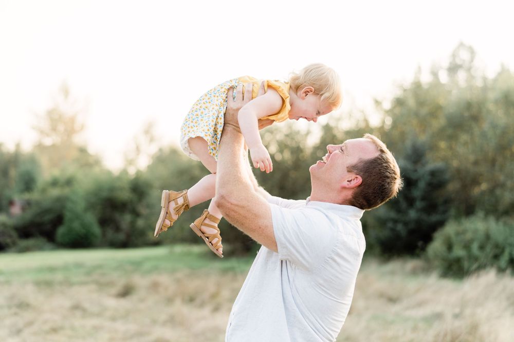 dad and daughter playing at sunset rustic field fun playful lifestyle photographer c photography