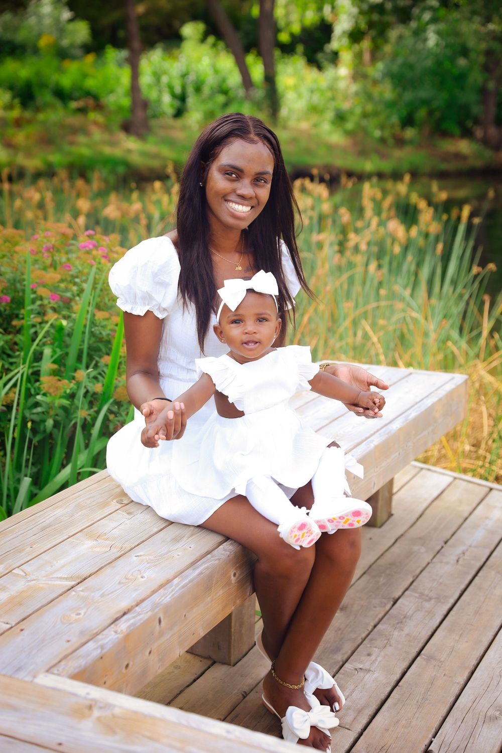 Beautiful outdoor portrait in a park setting with white dresses and natural greenery.