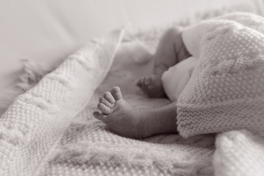 black and white photo of baby toes