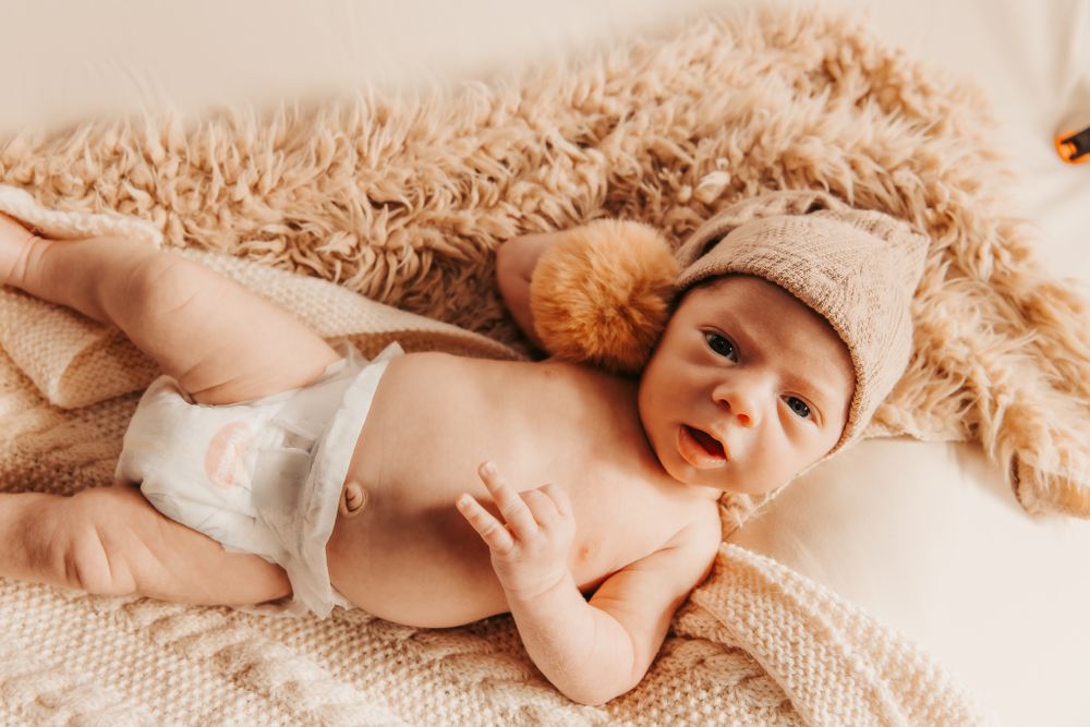 sleepy baby on tan coloured blankets