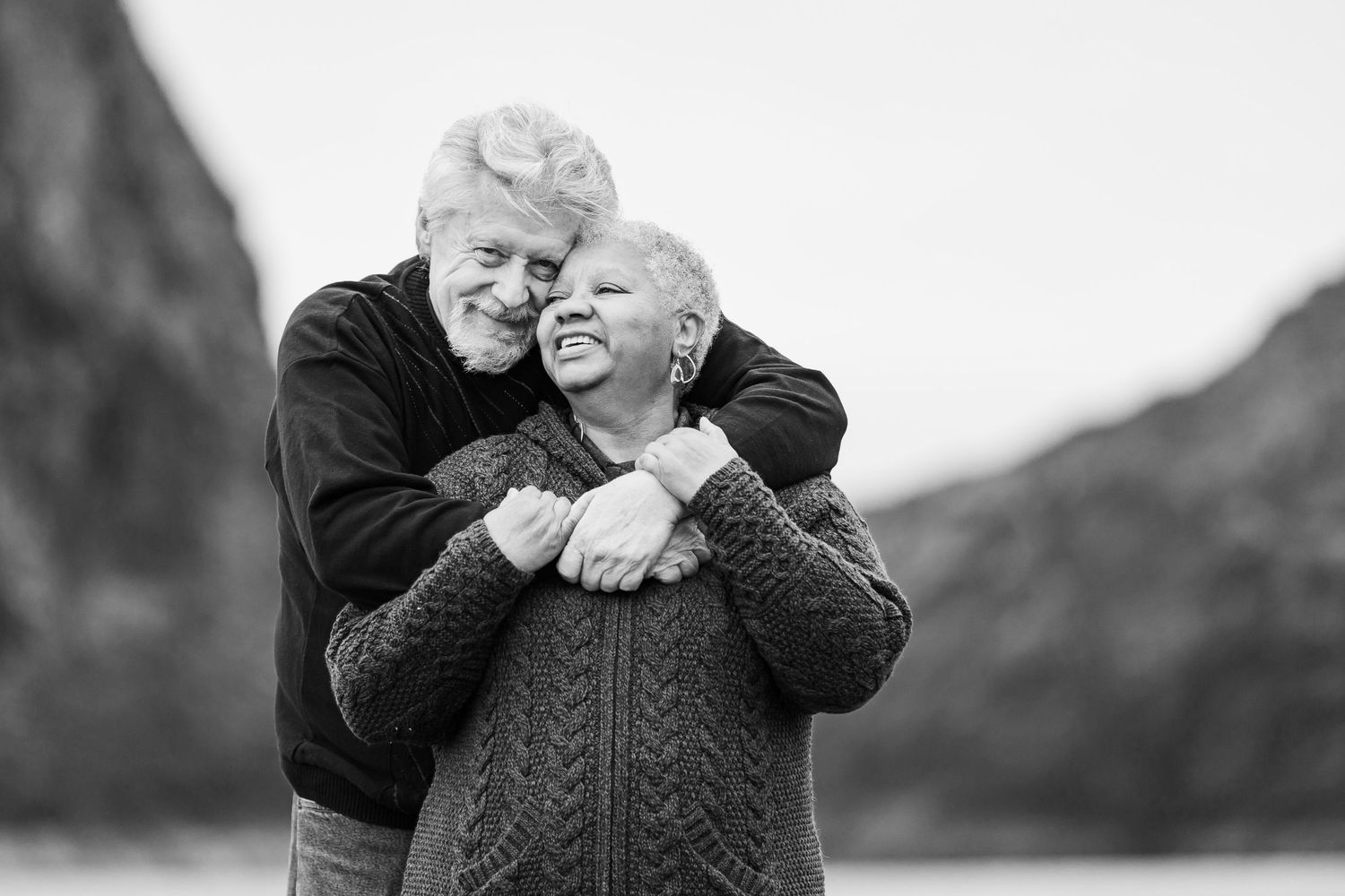 Sweet older couple getting their portrait taken by Taylor Carpenter Photography in Gold Beach, Oregon on the beach at Kissing Rock