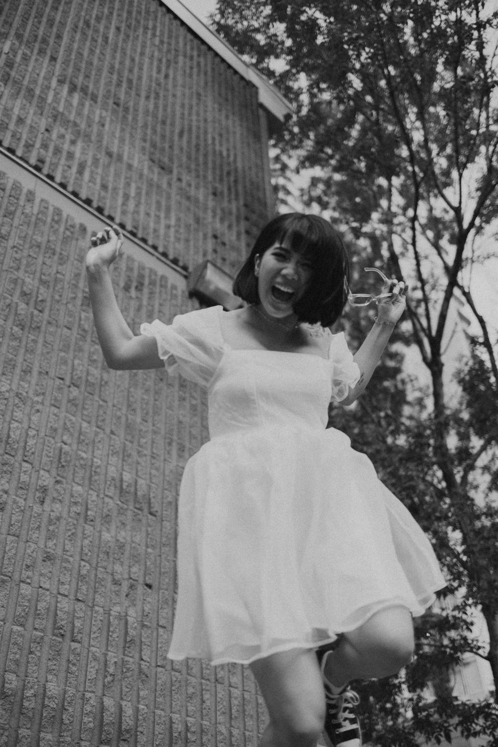Black and white photo series capturing dynamic movement and white flowing fabric outdoors.