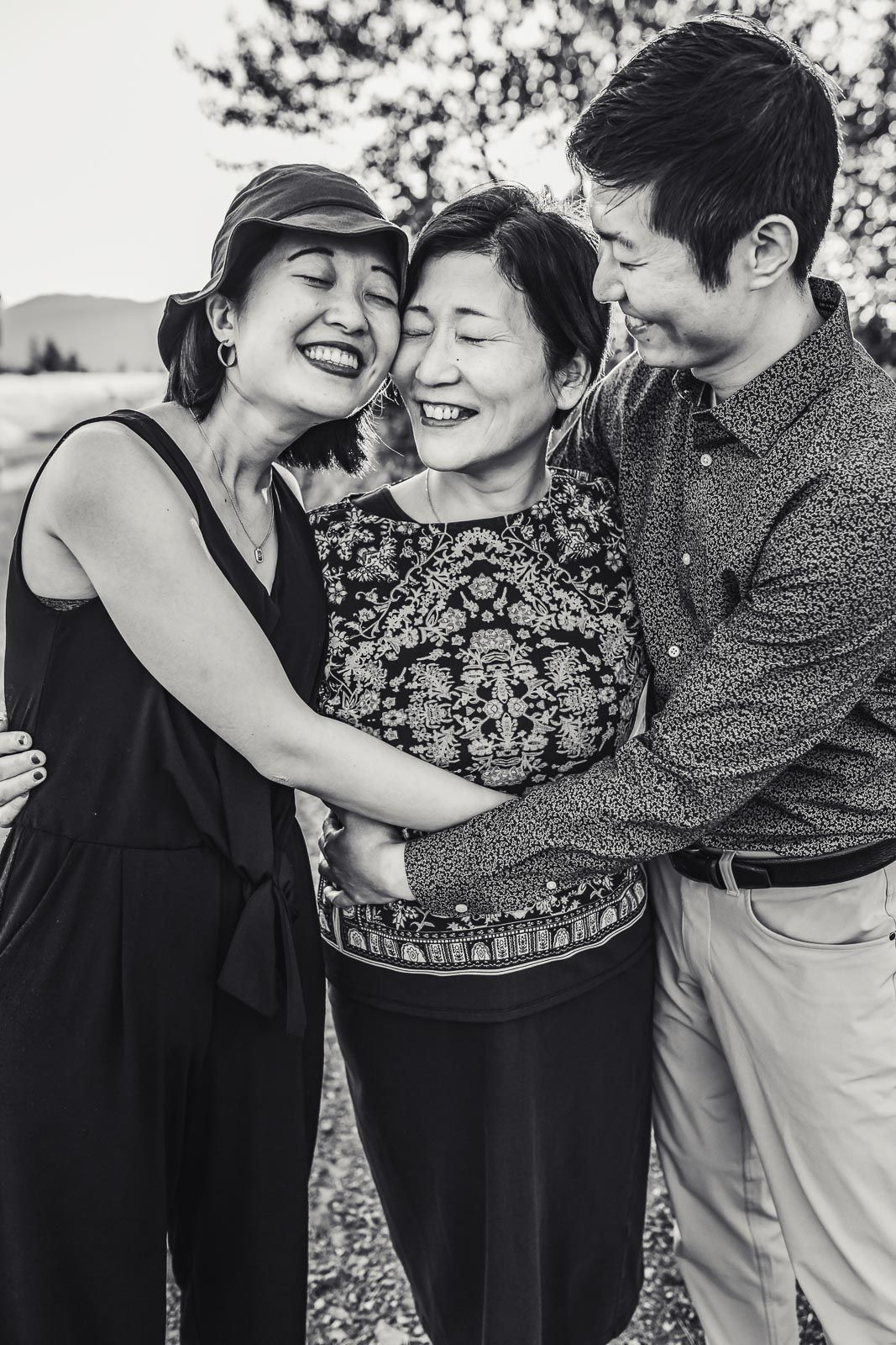 Black and white photo of mother with her adult children in the summer