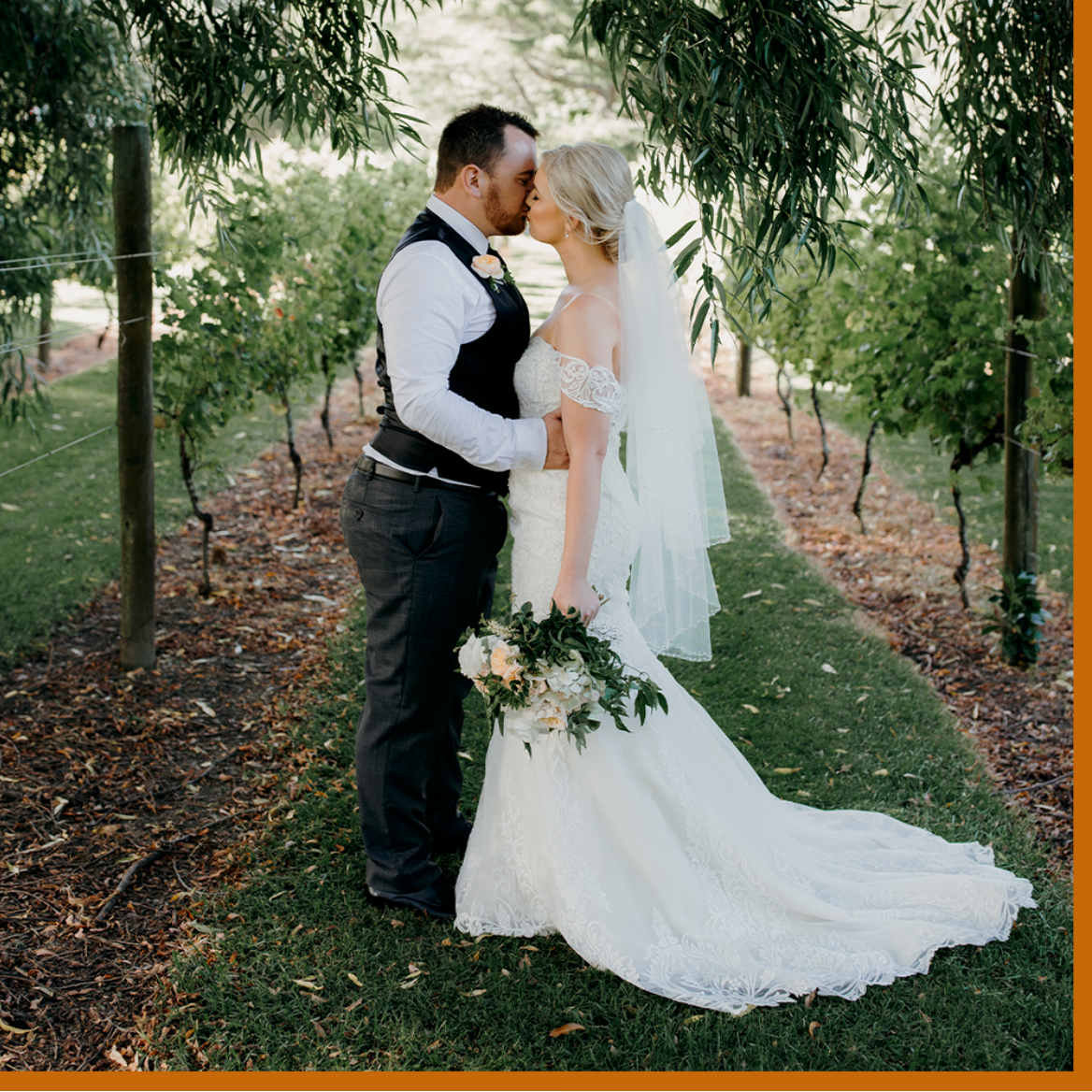gracehillvineyard estate wedding photo of couple in the vines kissing