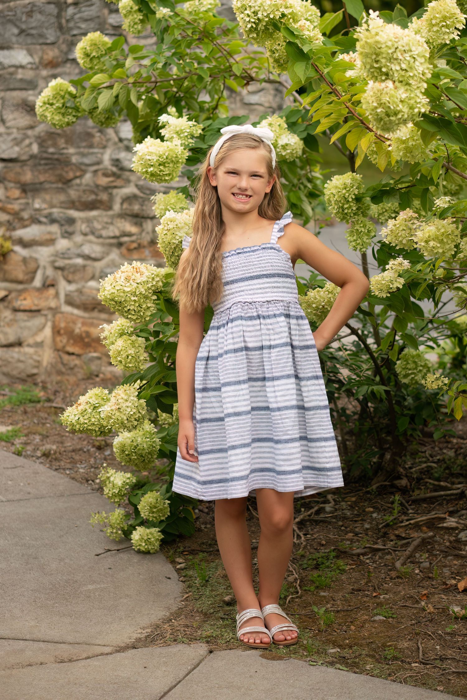 young girl stands for annual outdoor photo