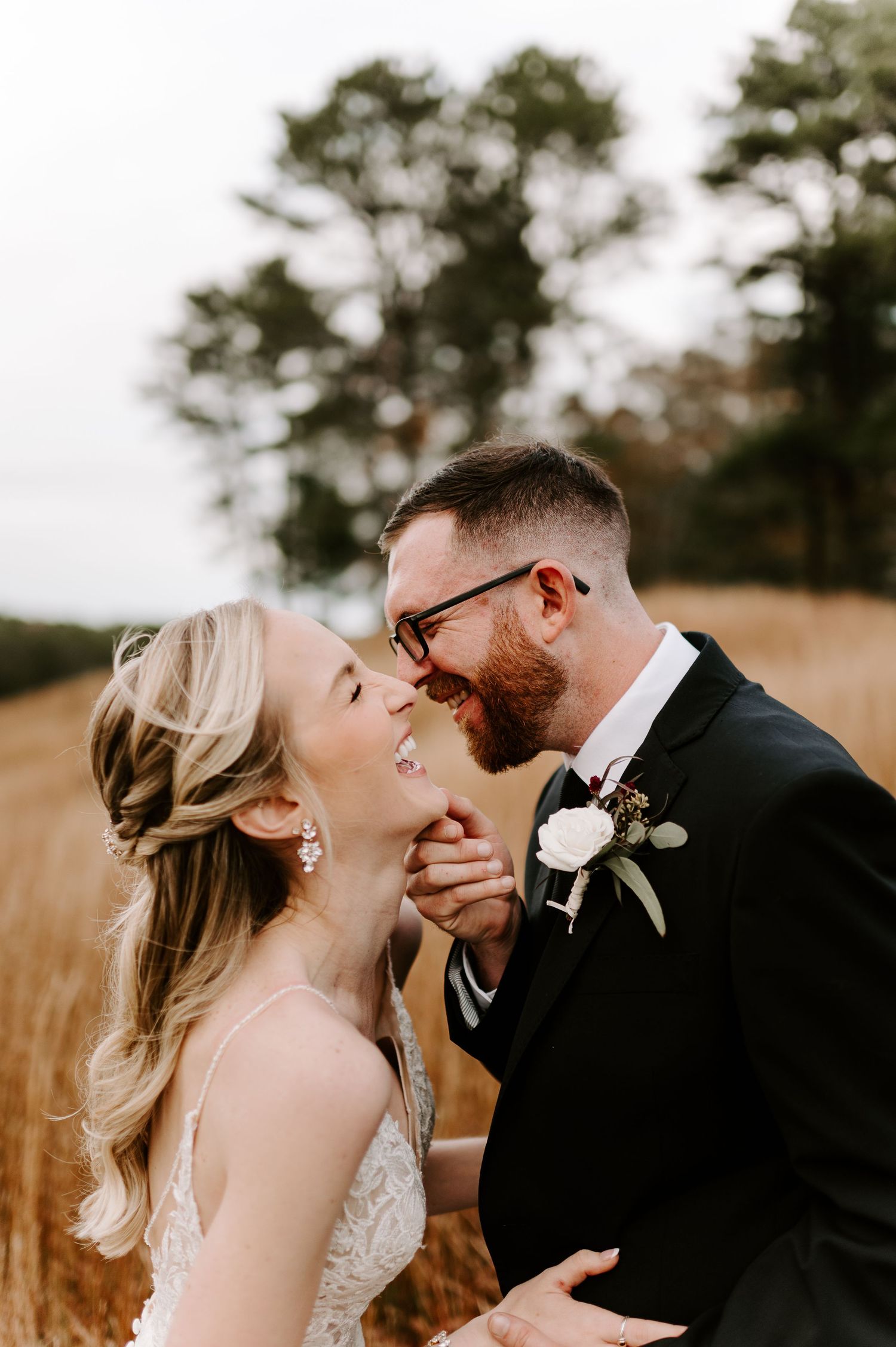 Intimate wedding portrait captured in a natural setting with warm fall colors.