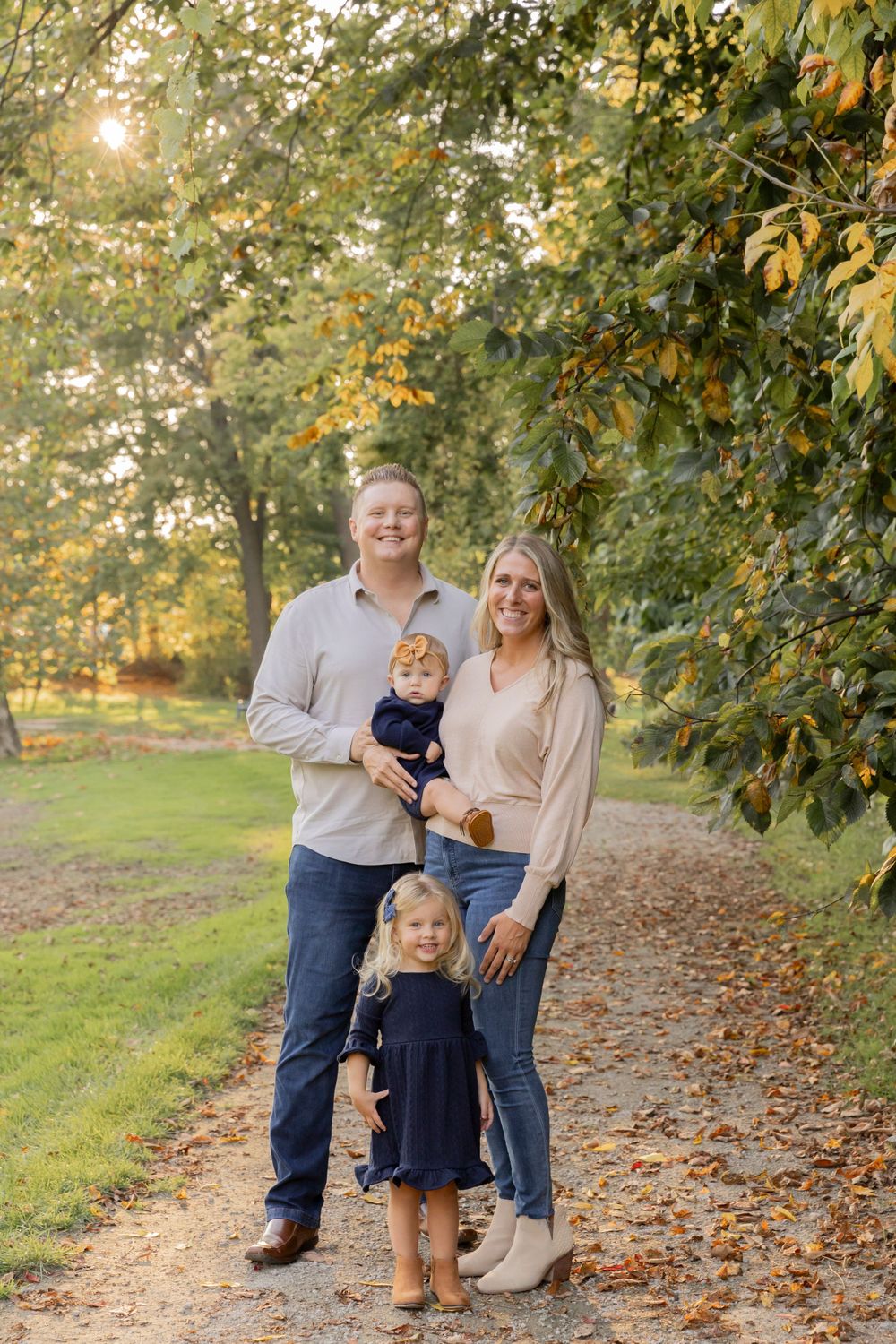 family of four wearing tans and blues poses for a photo at dodge park