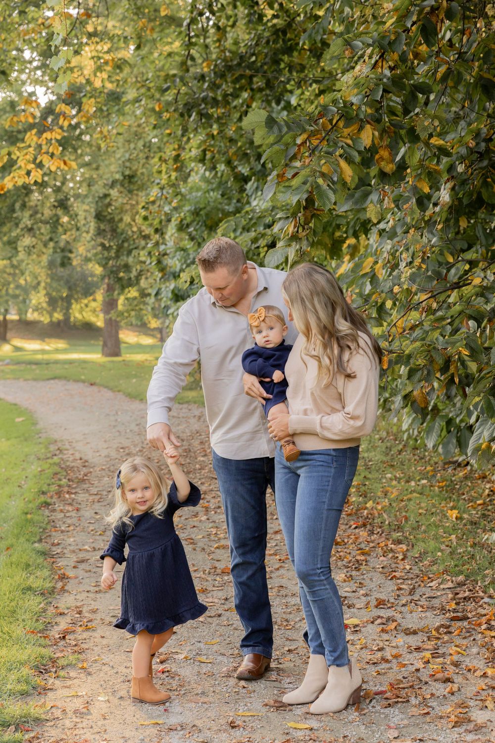 family of four dancing with their little girl at a park in sterling heights michigan