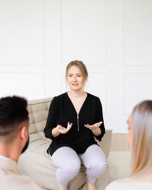 Bright, approachable branding portrait of a therapist smiling naturally by a window, highlighting authenticity and personality.