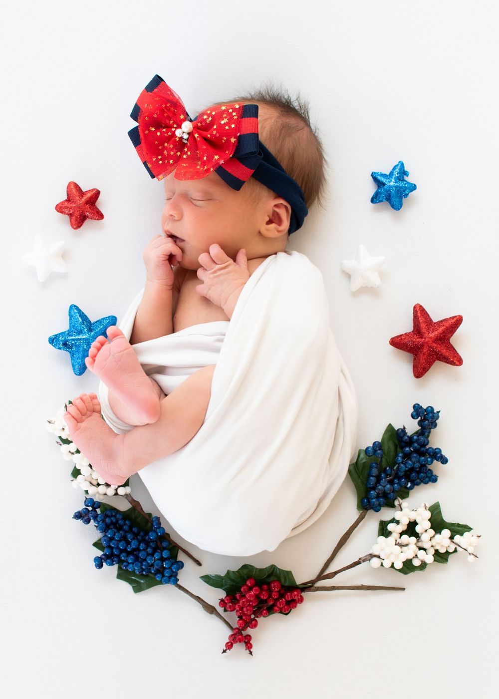 newborn daughter with red, white, blue decorations