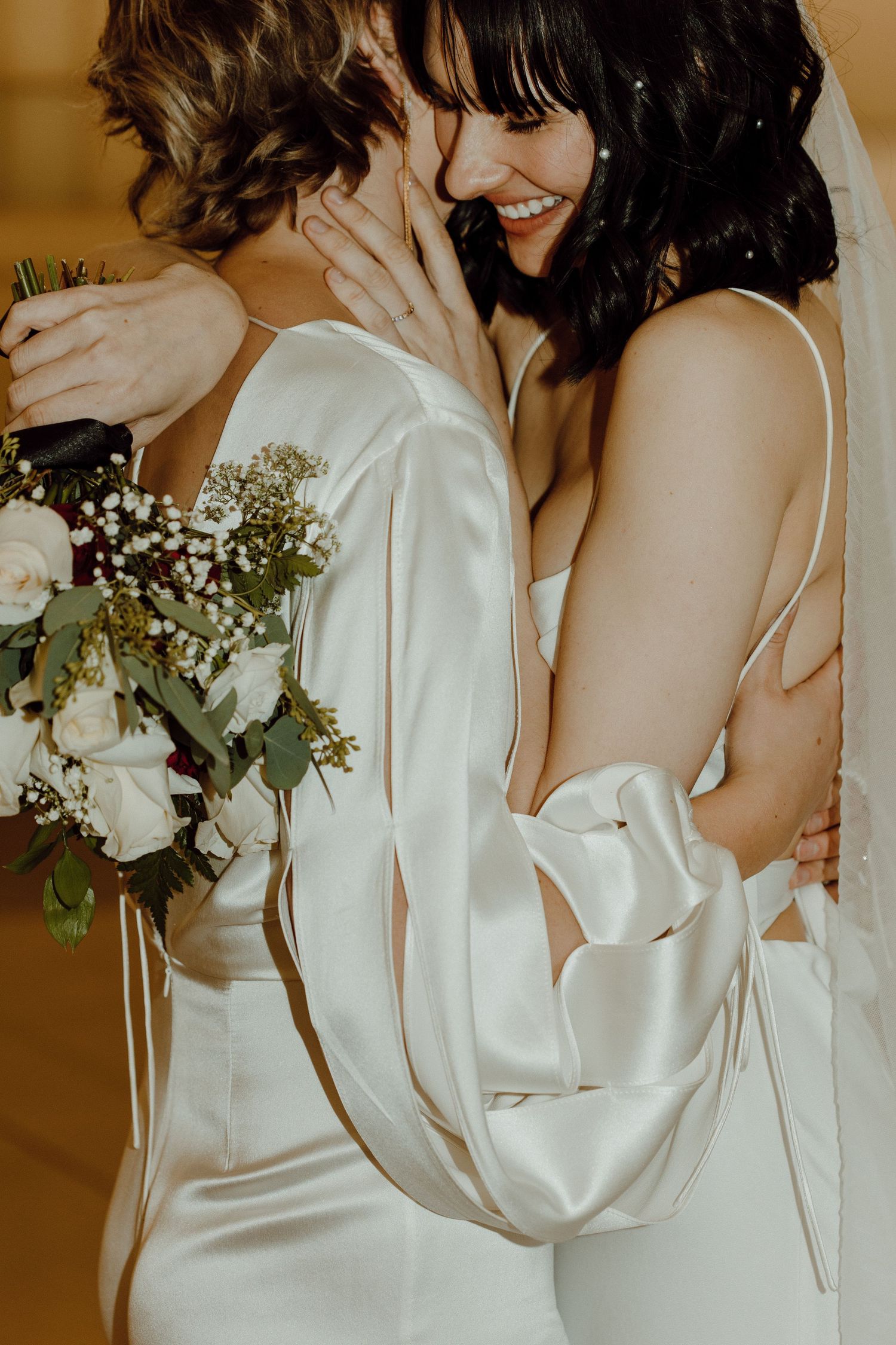 Gay/Lesbian couple embracing each other on their wedding day