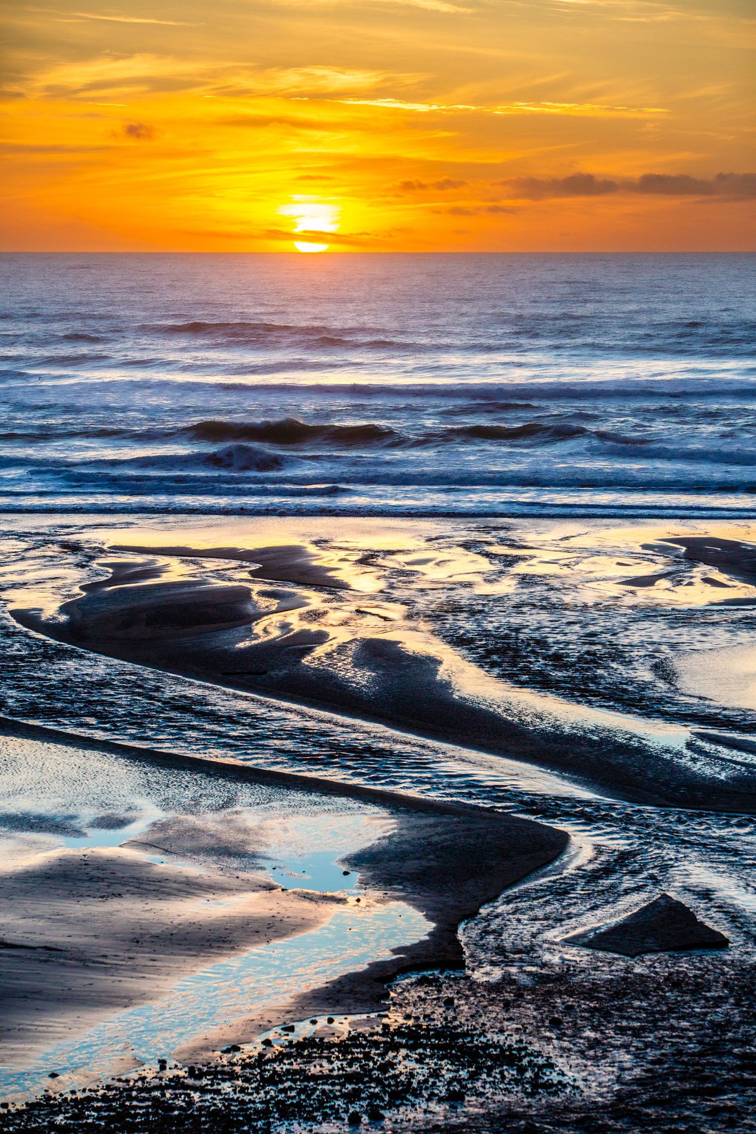 Sunset skies and wet sand at Beaverly Beach, Oregon