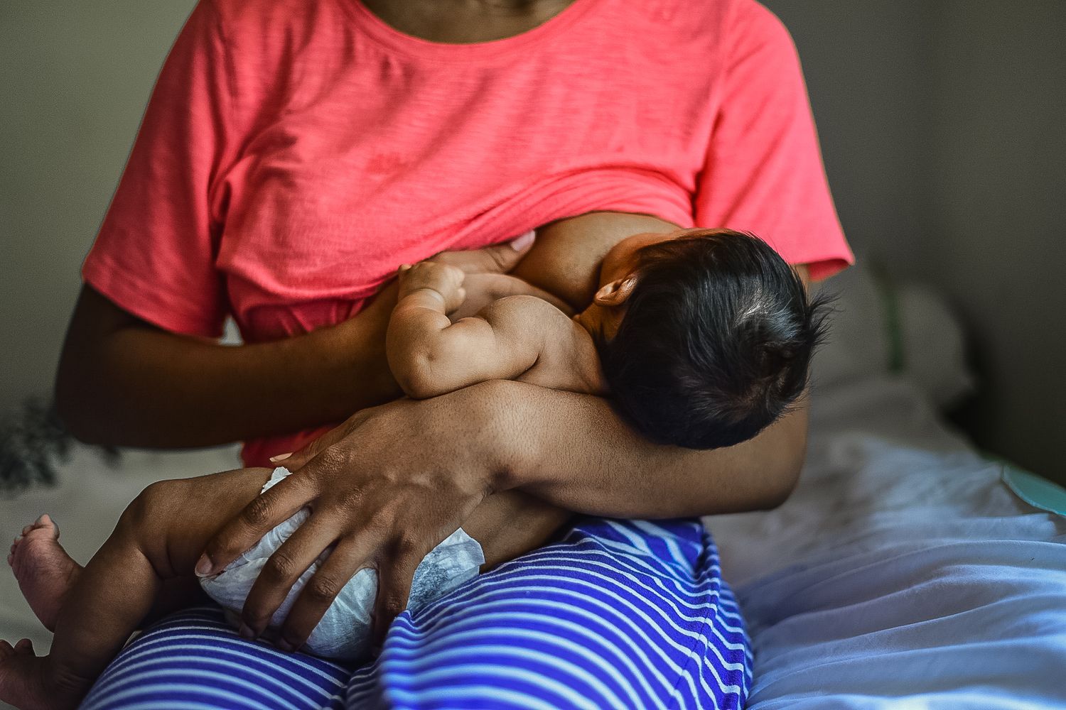 Black Woman Breastfeeding Baby In A Diaper