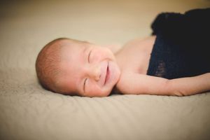 Series of peaceful newborn portraits showing soft, dreamy details in warm lighting.
