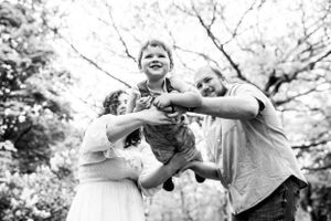 Black and white candid family moments outdoors.