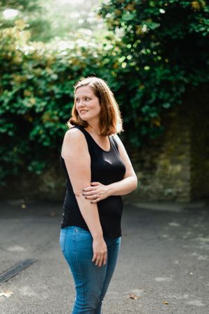Casual outdoor portraits in black top and jeans showing natural movement and expressions.