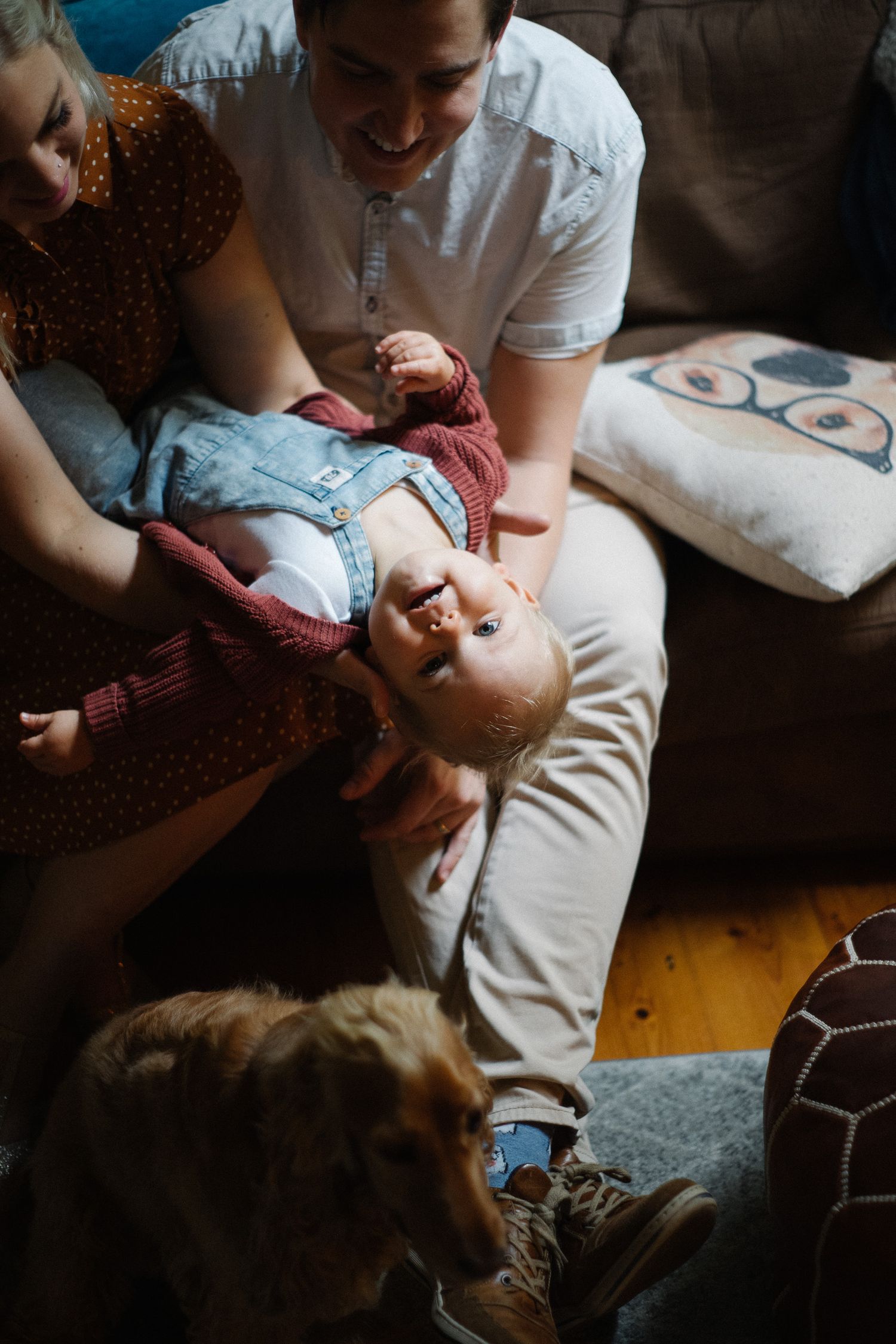 Child lying on mom’s lap, looking at the camera. Example of family photography by WhySoGeneric by Brandon.