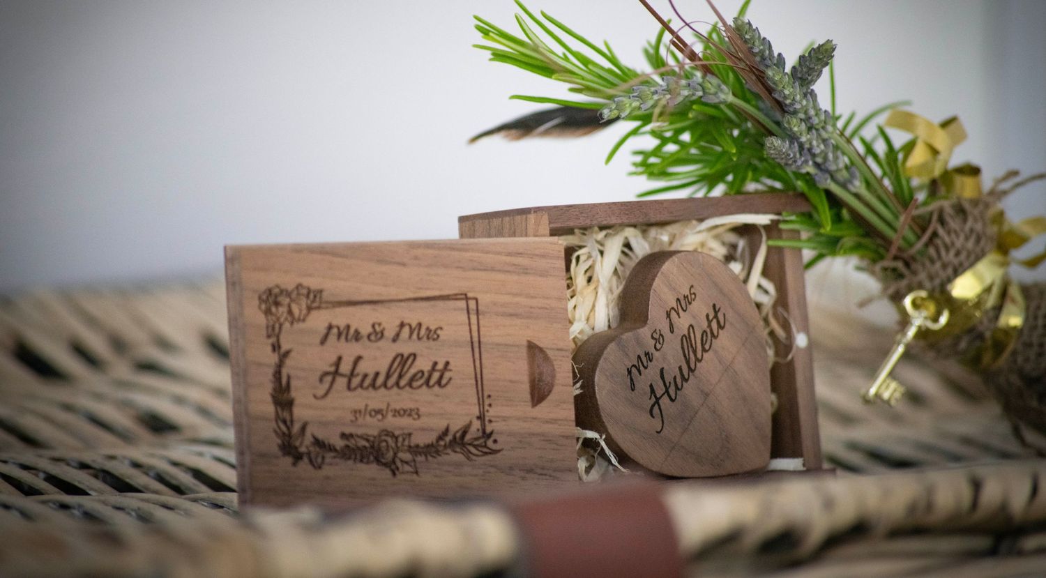 Rustic wedding favor packages with greenery and natural decor.