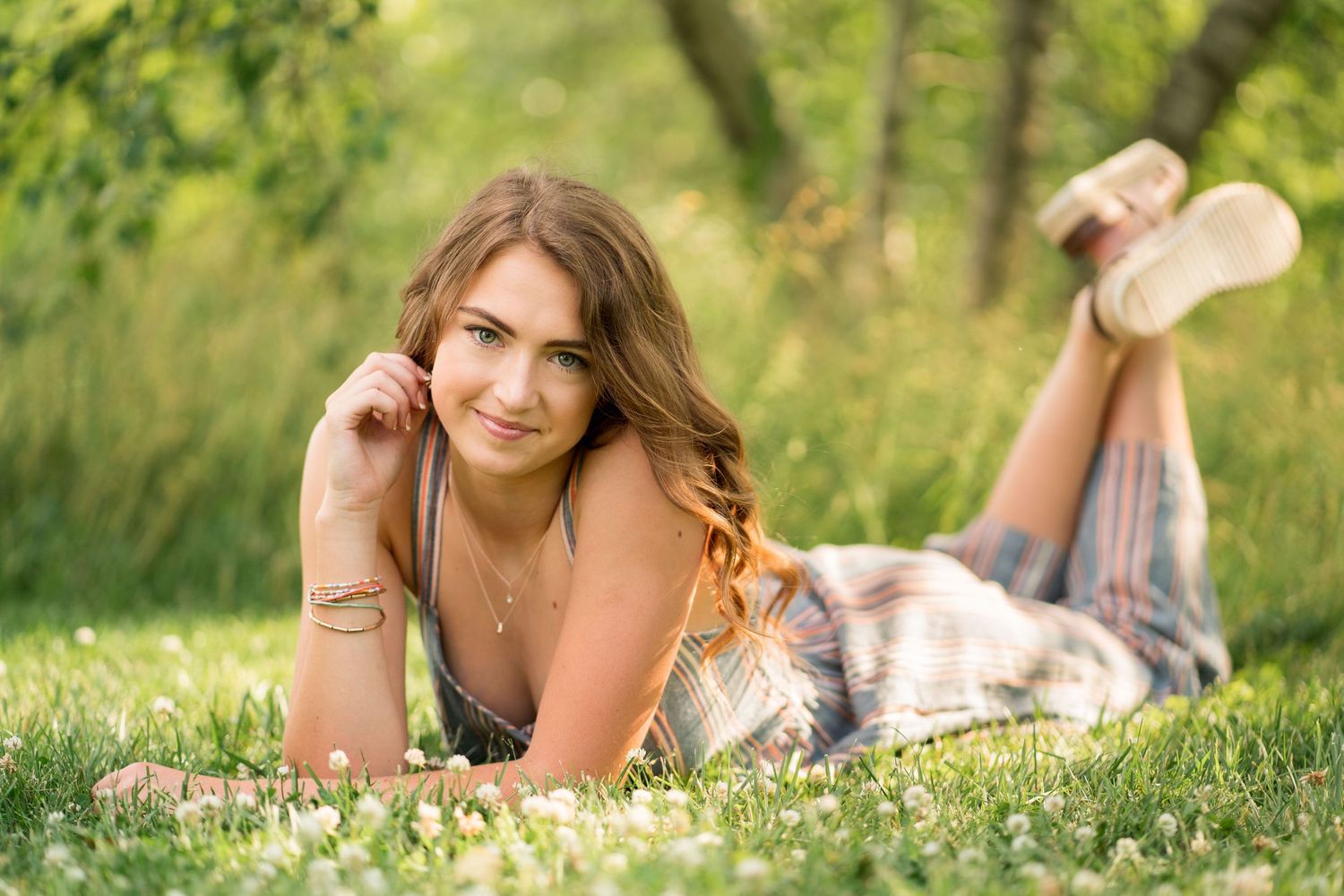 Summer portrait session in a field of wildflowers with soft natural lighting.
