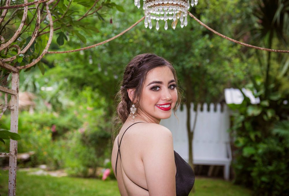 Garden prom photo with crystal chandelier decoration and greenery.