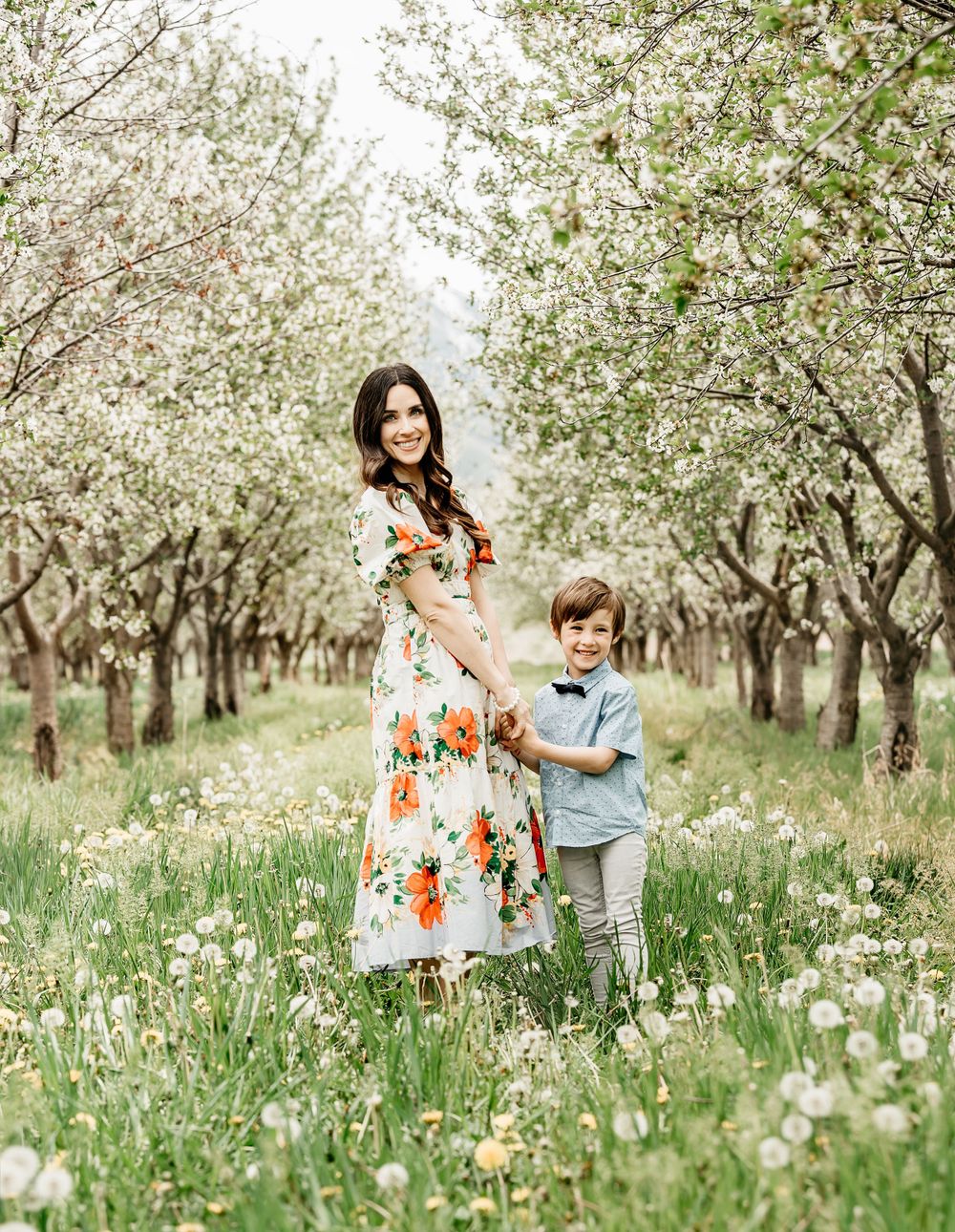 Spring portrait in blooming orchard with floral dress.
