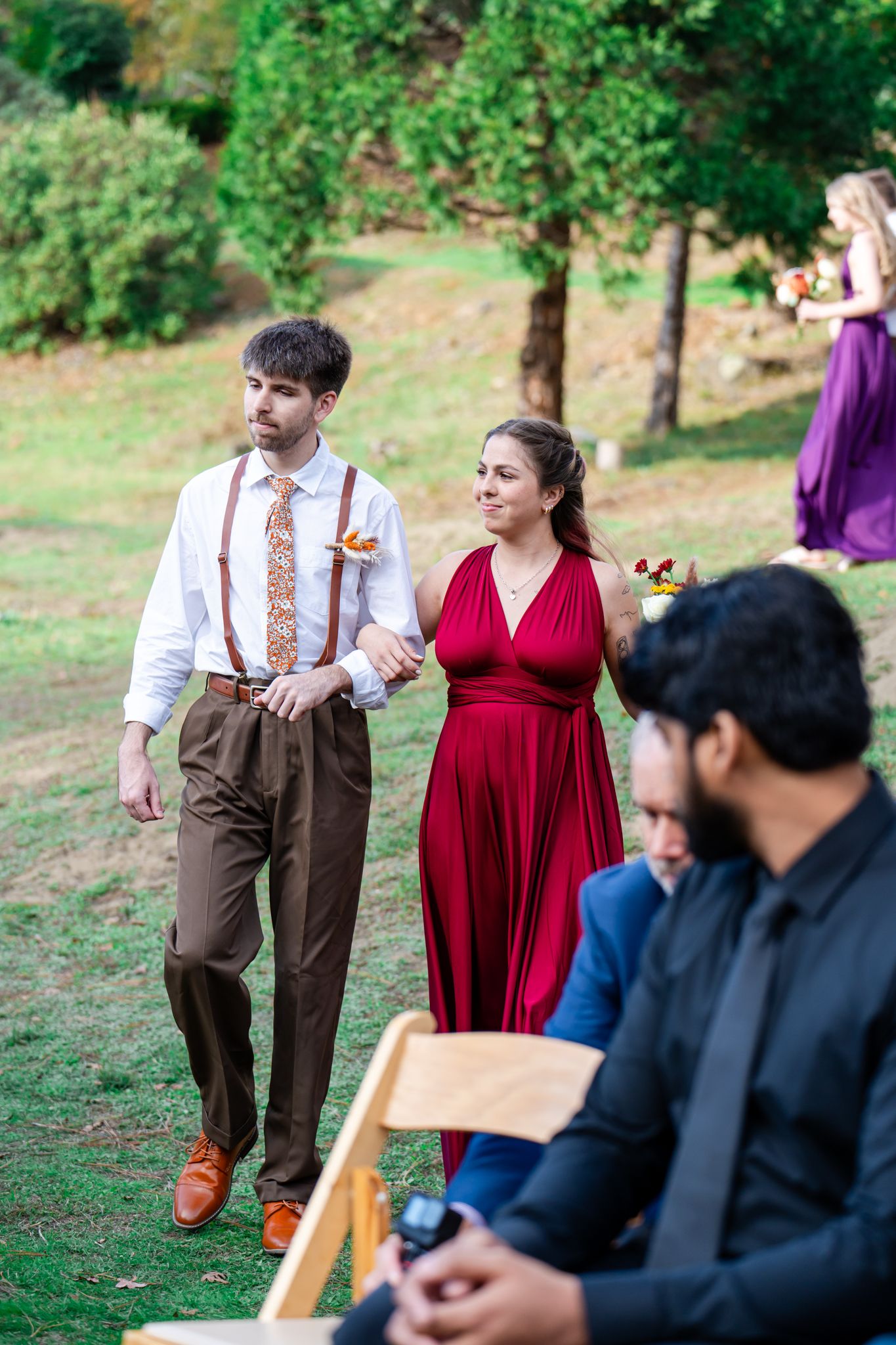 groomsman and bridesmaid in red