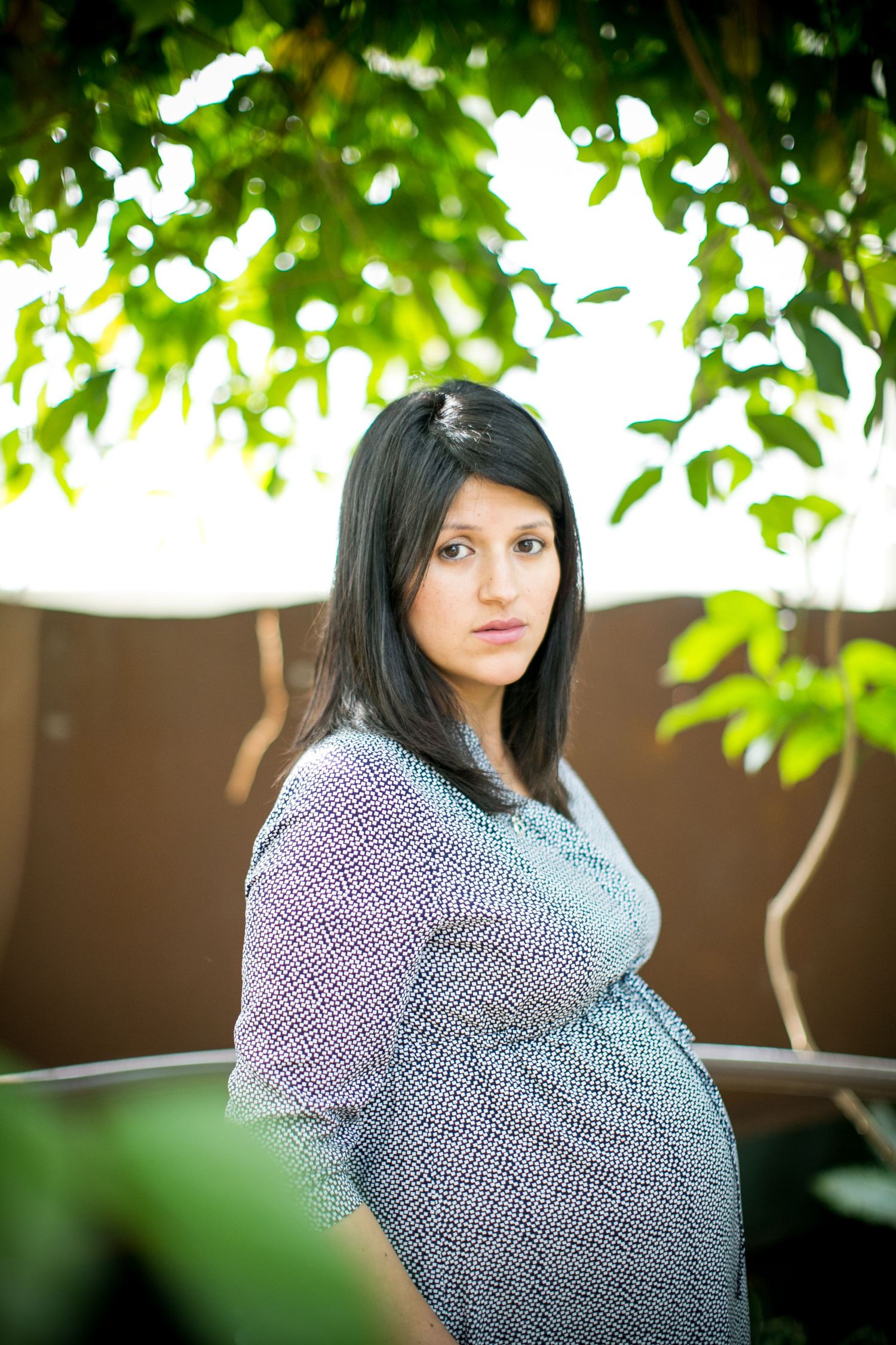 Portrait series in a garden setting with soft bokeh and green foliage.