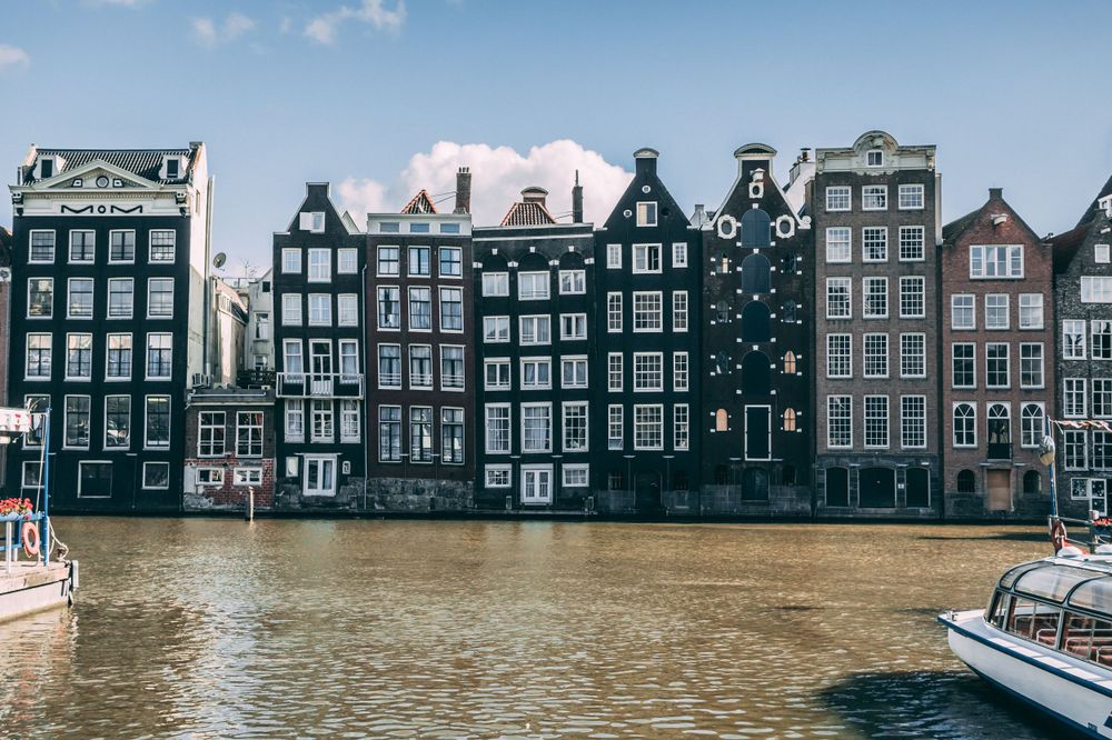 amsterdam canal houses blue skies