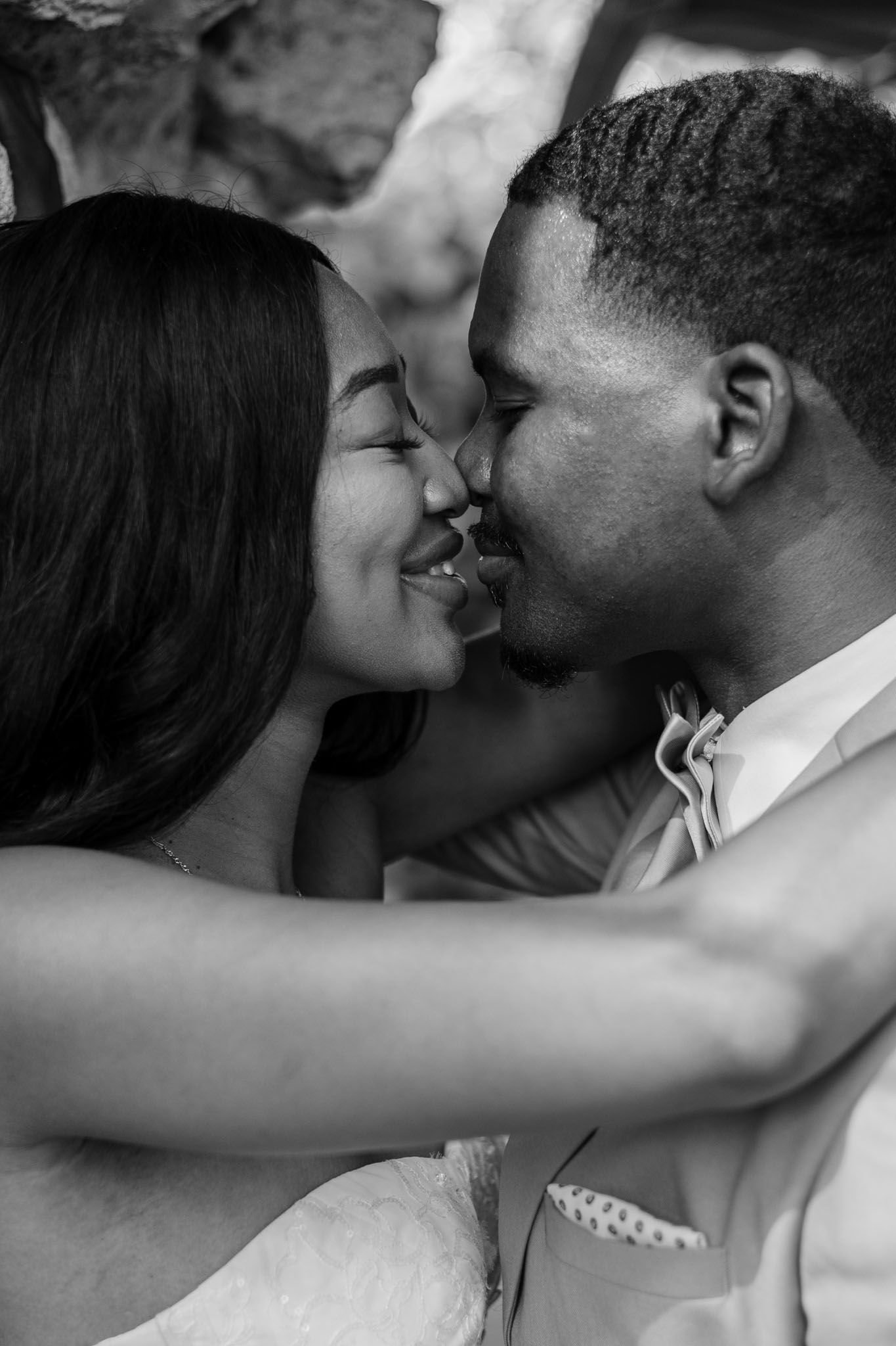 Bride and groom about to share a kiss at their wedding. Film-like black and white vintage wedding photography Lakeland