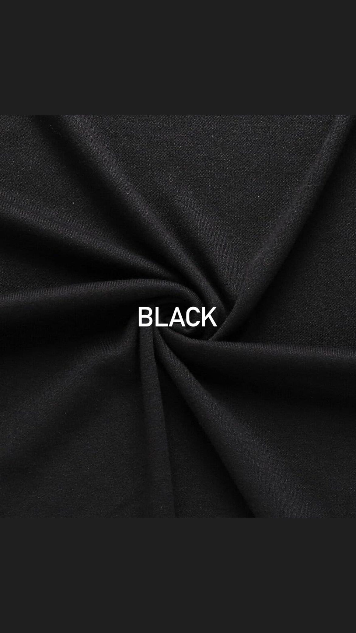 Black textile fabric with twisted center showing material texture and draping.