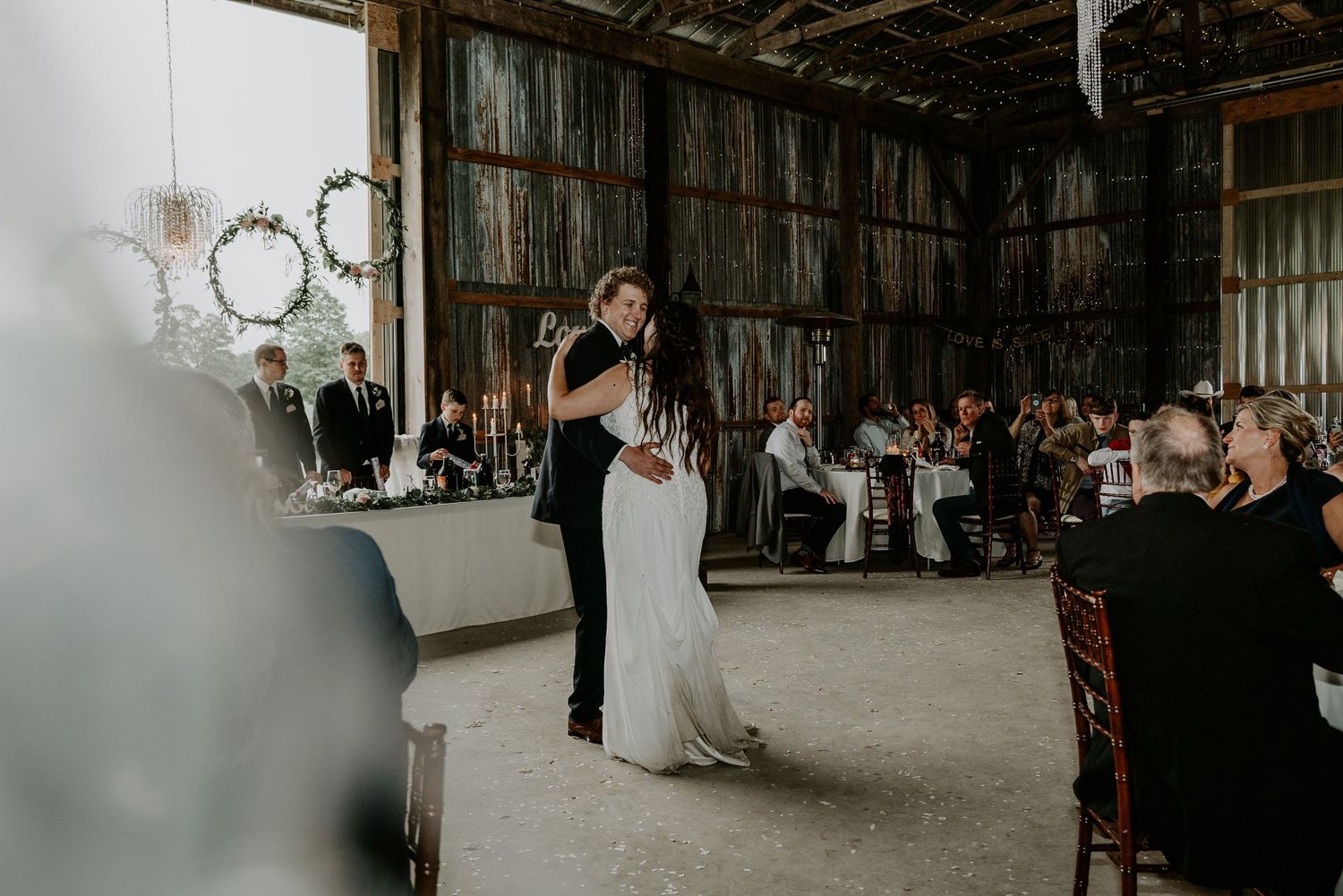bride and groom first dance in barn