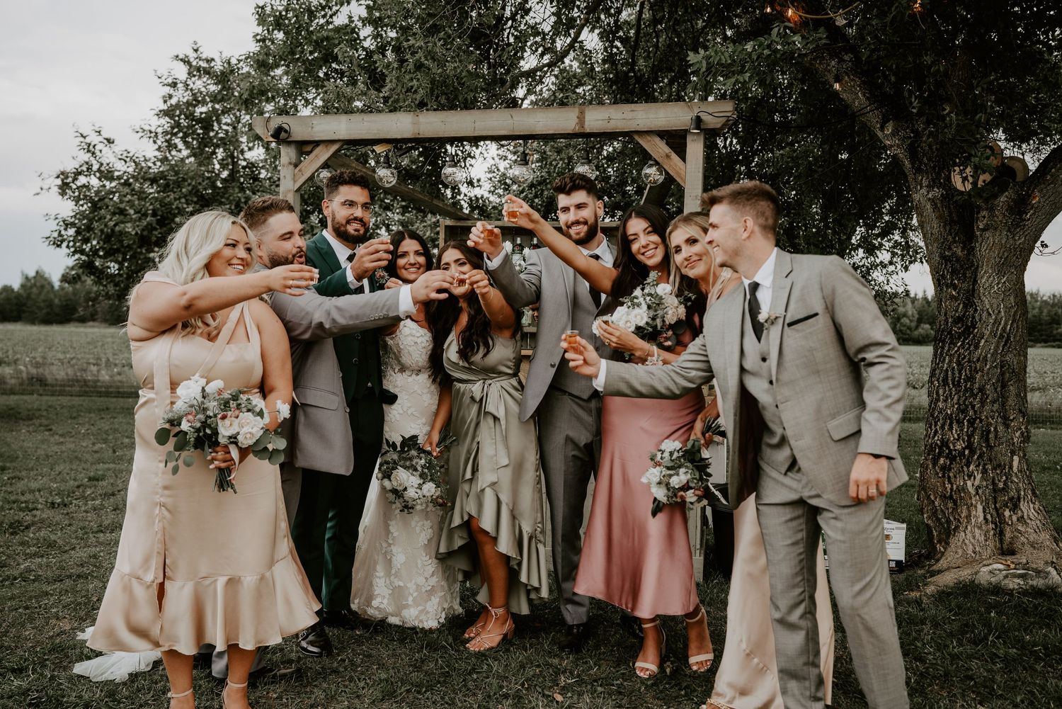Wedding party cheers to bride and groom