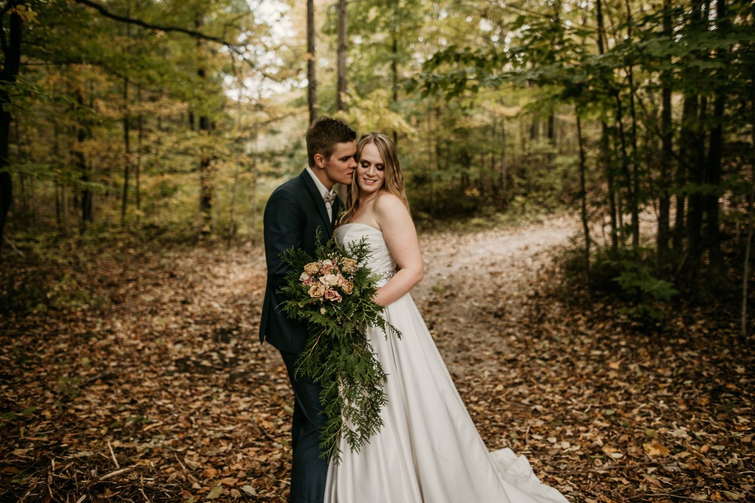 groom about to kiss bride on cheek
