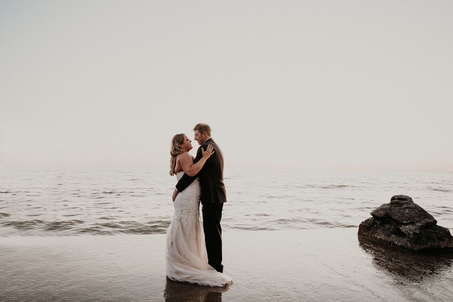 husband and wife dance by water
